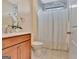 Bright bathroom with vanity, marble-look tile detail, and shower with curtain at 411 Southbridge Pass, Peachtree City, GA 30269