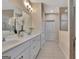 Bright bathroom featuring double vanity, white cabinetry, and tile flooring at 411 Southbridge Pass, Peachtree City, GA 30269
