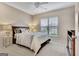 Well-lit bedroom featuring a ceiling fan, plush carpet, and a window with natural light at 411 Southbridge Pass, Peachtree City, GA 30269