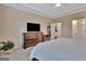 Bedroom with hardwood floors, large dresser, and neutral colors at 411 Southbridge Pass, Peachtree City, GA 30269