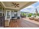 Outdoor deck with seating areas, ceiling fan, and a relaxing view at 411 Southbridge Pass, Peachtree City, GA 30269
