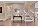 Elegant foyer with staircase, decorative table, and hardwood flooring at 411 Southbridge Pass, Peachtree City, GA 30269
