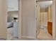 Hallway view of bedroom and bathroom, with neutral tones and carpet flooring at 411 Southbridge Pass, Peachtree City, GA 30269