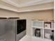 Organized laundry room with modern washer/dryer and shelving for storage at 411 Southbridge Pass, Peachtree City, GA 30269