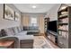 Cozy living room with a comfortable sectional sofa and built in shelving at 411 Southbridge Pass, Peachtree City, GA 30269