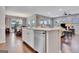 Spacious living area featuring a large kitchen island with dining and seating area, lots of natural light, and hardwood floors at 411 Southbridge Pass, Peachtree City, GA 30269