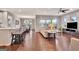 Open concept living room with hardwood floors, flowing into the kitchen and dining areas at 411 Southbridge Pass, Peachtree City, GA 30269