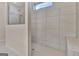Modern bathroom shower featuring white tiles, glass doors, and a built-in bench at 411 Southbridge Pass, Peachtree City, GA 30269