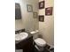 Functional bathroom featuring a vanity with a sink, toilet, and decorative touches, creating a tidy and practical space at 1063 Nw Cato Nw St, Atlanta, GA 30318