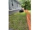 A view of the side yard showing the side of the home and the lawn at 1063 Nw Cato Nw St, Atlanta, GA 30318