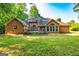 Spacious backyard featuring a deck, mature trees, and a well-maintained brick home at 195 Youngs Cir, Fayetteville, GA 30215