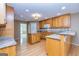 Well-lit kitchen with hardwood floors, center island and granite counters at 195 Youngs Cir, Fayetteville, GA 30215