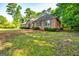 Lovely single-story brick home surrounded by mature trees and a well-manicured lawn at 195 Youngs Cir, Fayetteville, GA 30215
