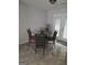 Cozy dining area featuring a glass table, four chairs, and bright natural light from the patio doors at 35 Hampton Oaks Dr, Hampton, GA 30228