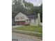 Charming home featuring a two-car garage, green siding, and mature trees, perfect for suburban living at 35 Hampton Oaks Dr, Hampton, GA 30228