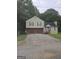 Inviting two-story home with a two-car garage, well-maintained lawn, and a cozy front porch at 35 Hampton Oaks Dr, Hampton, GA 30228
