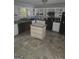 Spacious kitchen featuring light cabinets, an island, granite countertops, and stainless steel appliances at 35 Hampton Oaks Dr, Hampton, GA 30228