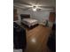 Comfortable bedroom featuring a ceiling fan, wood floors, and large windows, creating a relaxing ambiance at 35 Hampton Oaks Dr, Hampton, GA 30228