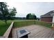 Wooden deck with a fire pit table overlooking a lush, green backyard at 1204 Bent Creek Dr, Mcdonough, GA 30252