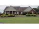 Charming brick home featuring a well-manicured lawn and a welcoming front porch with classic white columns at 1204 Bent Creek Dr, Mcdonough, GA 30252