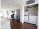 Kitchen adjacent to laundry area, showcasing modern appliances and white cabinetry at 1204 Bent Creek Dr, Mcdonough, GA 30252