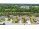 Beautiful aerial shot of neighborhood with lush trees; home features dual porches and large manicured lawn at 206 Roundwood Way, Peachtree City, GA 30269