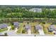 Aerial view of a suburban home with a well-manicured lawn and mature trees at 206 Roundwood Way, Peachtree City, GA 30269