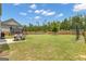 Spacious backyard with a large lawn, wooden fence, and a trampoline at 206 Roundwood Way, Peachtree City, GA 30269