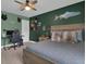 Bedroom with a rustic wood bedframe, muted green walls and desk with computer setup at 206 Roundwood Way, Peachtree City, GA 30269