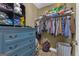 Organized walk-in closet with blue dresser, wire shelving, and clothing storage at 206 Roundwood Way, Peachtree City, GA 30269