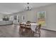 Dining area features a modern chandelier and views to the backyard through large windows at 206 Roundwood Way, Peachtree City, GA 30269