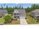 Charming two-story home features a welcoming porch, two-car garage, and lush landscaping at 206 Roundwood Way, Peachtree City, GA 30269