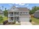 Charming two-story home with double porch, landscaped yard, and two car garage at 206 Roundwood Way, Peachtree City, GA 30269