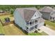 This two-story home features a double front porch, inviting curb appeal, green lawn, and a convenient two-car garage at 206 Roundwood Way, Peachtree City, GA 30269