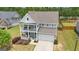 Two-story home with a welcoming front porch and upper balcony, complemented by a well-manicured lawn and a two car garage at 206 Roundwood Way, Peachtree City, GA 30269
