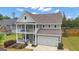 Charming two-story home with a double balcony and inviting curb appeal at 206 Roundwood Way, Peachtree City, GA 30269