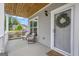 Inviting front porch with comfortable seating, wood ceiling, and charming wreath at 206 Roundwood Way, Peachtree City, GA 30269