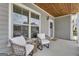 Inviting front porch with comfortable seating, wood ceiling, and charming wreath at 206 Roundwood Way, Peachtree City, GA 30269