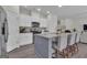 Kitchen boasts stainless steel appliances, an island, and seamlessly connects to the living room at 206 Roundwood Way, Peachtree City, GA 30269