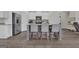 Kitchen island features stone countertops, bar stool seating, and a stainless steel sink at 206 Roundwood Way, Peachtree City, GA 30269