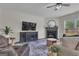 Cozy living room features a fireplace, ceiling fan, and comfortable seating at 206 Roundwood Way, Peachtree City, GA 30269