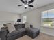 Comfortable living room featuring a large sofa with cushions and natural light from windows at 206 Roundwood Way, Peachtree City, GA 30269