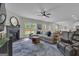 Bright living room with fireplace and large windows offering backyard views at 206 Roundwood Way, Peachtree City, GA 30269