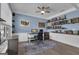 Stylish home office with custom built-in shelves, accent wall, and modern furnishings at 206 Roundwood Way, Peachtree City, GA 30269