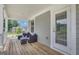 Relaxing covered porch with seating and a view of the well-maintained neighborhood landscape at 206 Roundwood Way, Peachtree City, GA 30269