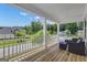 Covered porch offering outdoor seating with a view of the neighborhood and trees at 206 Roundwood Way, Peachtree City, GA 30269