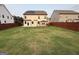 Wide shot of the large backyard with grass, a fence, and a gazebo at 442 Snow Owl Way, Lawrenceville, GA 30044