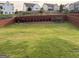 Spacious, grass-covered backyard with a wooden fence and garden at 442 Snow Owl Way, Lawrenceville, GA 30044