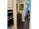 Elegant bar area adjacent to a modern kitchen, showcasing a stylish cabinet and a decorative painting at 442 Snow Owl Way, Lawrenceville, GA 30044