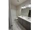 Bathroom featuring tiled floors, a tub with shower, and a double sink vanity at 442 Snow Owl Way, Lawrenceville, GA 30044